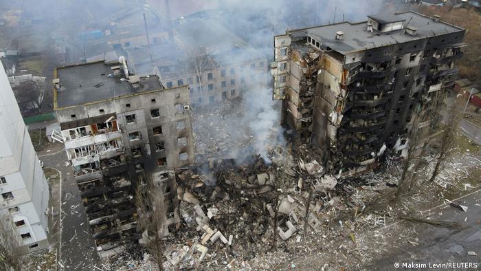 An aerial view shows a residential building destroyed by shelling.