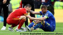 June 5, 2022, Cardiff, United Kingdom: Cardiff, Wales, 5th June 2022. Ben Davies of Wales checks on Andriy Yarmolenko of Ukraine following their defeat during the FIFA World Cup 2022 - European Qualifying match at the Cardiff City Stadium, Cardiff. Photo via Newscom picture alliance