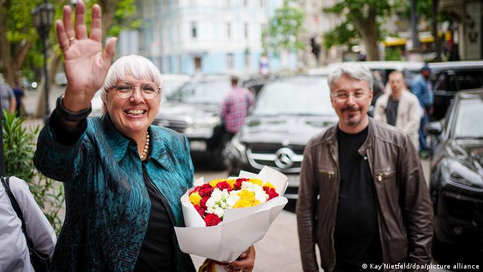 Claudia Roth waves to camera, stood next to Ukraine's Culture Minister Oleksandr Tkachenko. June 6, 2022. 