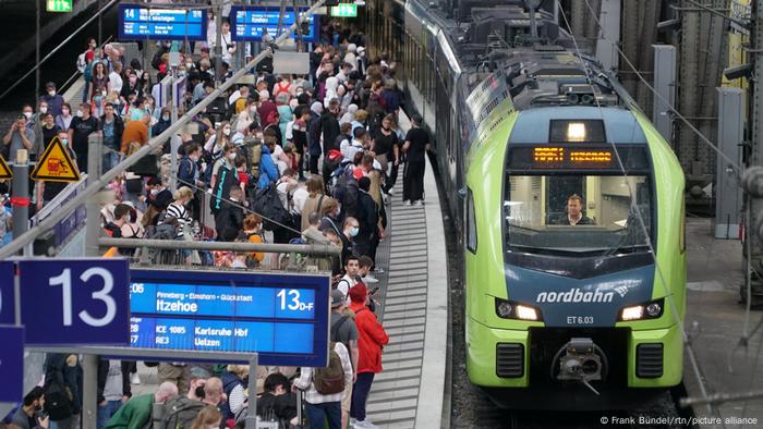 At Hamburg's main station, many people are waiting for a train.