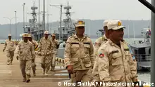 Cambodian navy troop members walk at Ream Naval Base in Sihanoukville, southwestern of Phnom Penh, Cambodia on July 26, 2019. Cambodia's government on Monday, Oct. 5, 2020, officially denied suggestions that its demolition of a U.S.-funded facility at one of its naval bases is a signal that China will be granted basing privileges there, saying the work only involves planned infrastructure improvements.(AP Photo/Heng Sinith)