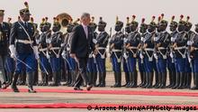 Belgium's King Philippe (C) inspects the guard of honour upon his arrival at the N'djili International Airport in Kinshasa on June 7, 2022. - Belgium's King Philippe landed in the Democratic Republic of Congo on June 7, 2022 in a historic visit to the central African country his ancestor once ruled brutally as his personal fief. The monarch will undertake a six-day trip billed as a chance for reconciliation after atrocities committed under Belgian colonial rule. The visit comes two years after Philippe wrote to Congolese President Felix Tshisekedi to express his deepest regrets for the wounds of the past. (Photo by Arsene Mpiana / AFP) (Photo by ARSENE MPIANA/AFP via Getty Images)