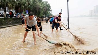 Residentes limpian la orilla del río en Liuzhou, en la región autónoma de Guangxi.