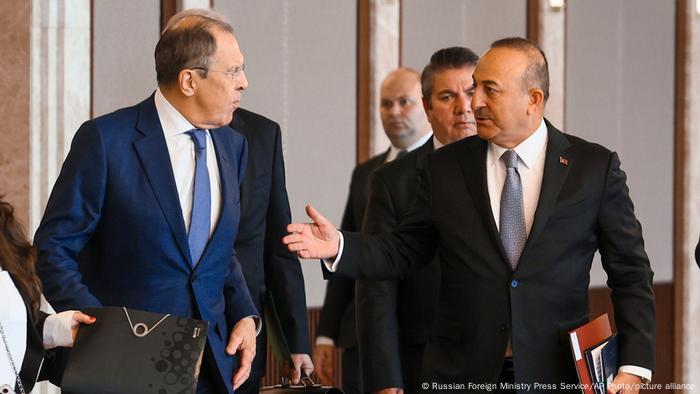 Lavrov and Mevlut Cavusoglu look at each other