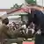 Belgian King Philippe shakes hands with WWII veteran Albert Kunyuku
