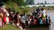 Myanmar refugees board a boat as they return home from Thailand Tuesday Myanmar refugees board a boat as they return home from Thailand Tuesday