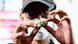 A man looks at a dried cannabis flower for sale A man looks at a dried cannabis flower for sale