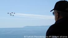 In this handout photo provided by the Turkish Presidency, Turkish President Recep Tayyip Erdogan watches jet fighters fly past during the final day of military exercises that were taking place in Seferihisar near Izmir, on Turkey's Aegean coast, Thursday, June 9, 2022. Erdogan on Thursday warned Greece to demilitarize islands in the Aegean, saying he was not joking with such comments. Turkey says Greece has been building a military presence on Aegean in violation of treaties that guarantee the unarmed statues of the islands. (Turkish Presidency via AP)