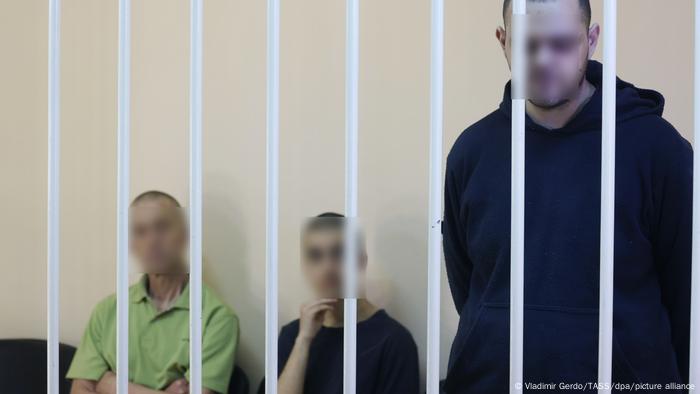 Aiden Aslin, Shaun Pinner and Brahim Saadoun in a prison cell