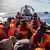 A dinghy full of refugees being rescued by a Spanish NGO, Open Arms, off the Libyan coast.