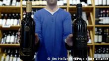 30.112015
epa05049028 Oded, who works in a central west Jerusalem wine and spirits shop, displays two bottles of wines 30 November 2015 from two Israeli wineries, both of which are produces in the West Bank, or pre-1967 Arab lands now controlled by Israel. Prime Minister Benjamin Netanyau has slammed the EU for demanding Israeli products made in the occupied territories are labeled as such. Netanyahu has ordered the Foreign Ministry tomsuspend contacts with representatives of some 16 countries over their orders to label such products, 'made in settlements' or 'made in the West Bank.' Both the wineries Psagot and Gva'ot are located in the West Bank, north of Jerusalem. EPA/JIM HOLLANDER ++ +++ dpa-Bildfunk +++