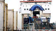 FILE - In this file photo dated Friday, Jan. 1, 2021, lorries and cars disembark from a ferry arriving from Scotland at the Port of Larne.