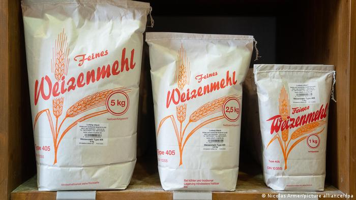 Different sizes of flour packs in a supermarket shelf