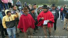 The president of the Confederation of Indigenous Nationalities in Ecuador (Conaie), Leonidas Iza (R), arrives to a road blocked by indigenous people and farmers in San Juan de Pastocalle, Cotopaxi province, Ecuador, on June 13, 2022. - Ecuador's main indigenous movement began a cycle of protests against the government of conservative President Guillermo Lasso on Monday, blocking roads in several provinces to demand lower fuel prices, local authorities said. (Photo by Cristina Vega RHOR / AFP) (Photo by CRISTINA VEGA RHOR/AFP via Getty Images)