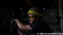 A Ukrainian service member walks at a position on the front line, amid Russia's attack on Ukraine, near the town of New York, Donetsk region, Ukraine June 14, 2022. REUTERS/Gleb Garanich