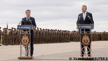 French President Emmanuel Macron and Romanian President Klaus Iohannis deliver statements as they visit NATO forces at the Mihail Kogalniceanu Air Base, near the city of Constanta, Romania, June 15, 2022. Yoan Valat/Pool via REUTERS