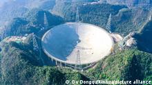 (220106) -- GUIZHOU, Jan. 6, 2022 (Xinhua) -- Aerial panoramic photo taken on Dec. 19, 2021 shows China's Five-hundred-meter Aperture Spherical Radio Telescope (FAST) under maintenance in southwest China's Guizhou Province. TO GO WITH China's FAST telescope detects coherent interstellar magnetic field (Xinhua/Ou Dongqu)