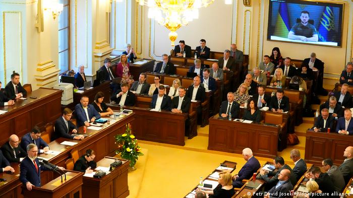 Ukraine's President Zelenskyy, seen on a screen, addresses the Czech parliament