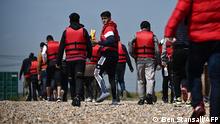 Migrants walk up the beach in Dungeness, on the southeast coast of England, on June 15, 2022, after being picked up at sea by a Royal National Lifeboat Institution's (RNLI) lifeboat while attempting to cross the English Channel.
are helped ashore from an - Furious Conservatives called on Britain's government on June 15, 2022 to abandon a European human rights pact after a judge dramatically blocked its plan to fly asylum-seekers to Rwanda. Under the UK's agreement with Rwanda, all migrants arriving illegally in Britain are liable to be sent to the East African nation thousands of miles away for processing and settlement. The government, after arguing that Brexit would lead to tighter borders, says the plan is needed to deter record numbers of migrants from making the perilous Channel crossing from northern France. (Photo by Ben Stansall / AFP)