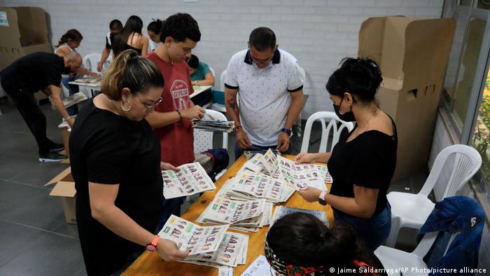  Election workers count ballots in Medellin, Colombia, Sunday, May 29, 2022. (AP Photo/Jaime Saldarriaga)