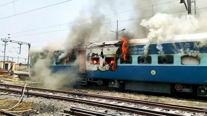 Army aspirants set ablaze a train during their protest against Agnipath scheme, at a railway station in Chhapra