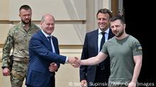 Ukrainian President Volodymyr Zelensky (R) shakes hands with Chancellor of Germany Olaf Scholz next to French president Emmanuel Macron (2ndR) ahead of a meeting in Kyiv on June 16, 2022, amid Russian invasion of Ukraine. (Photo by Sergei SUPINSKY / AFP) (Photo by SERGEI SUPINSKY/AFP via Getty Images)