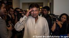 DUBAI, UAE - MARCH 24: Former Pakistani president, Pervez Musharraf salutes as he arrives to brief media and supporters during a press conference ahead of his return, at the Dubai APML party headquarters on March 24, 2013 in Dubai United Arab Emirates. The former Pakistani president and military ruler is returning to Pakistan after 4 years of self-imposed exile to participate in historic elections in May. Mr Musharraf has been granted protective bail in several cases, including conspiracy to murder which has paved his way allowing for his return. (Photo by Daniel Berehulak/Getty Images)