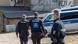 Three police officers walk towards a police vehicle parked in front of a house in Thuringia Three police officers walk towards a police vehicle parked in front of a house in Thuringia