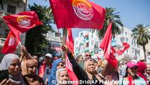 Supporters of the Tunisian General Labor Union (UGTT) gather during a rally outside its headquarters in Tunis, Tunisia, Thursday, June 16, 2022. A nationwide public sector strike in Tunisia is poised to paralyze land and air transportation and other vital activities Thursday with the North African nation already in the midst of a deteriorating economic crisis. (AP Photo/Hassene Dridi)