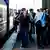German Chancellor OIaf Scholz walks through Kyiv's main train station accompanied by photographers, aides and soldiers