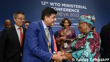 World Trade Organization Director-General Ngozi Okonjo-Iweala (R) is congratulated by Indian Minister of Commerce Piyush Goyal after a closing session of a World Trade Organization Ministerial Conference at the WTO headquarters in Geneva on early June 17, 2022. (Photo by Fabrice COFFRINI / POOL / AFP)
