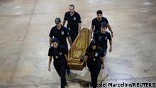 Federal Police officers carry a coffin containing human remains after a suspect confessed to killing British journalist Dom Phillips and Brazilian indigenous expert Bruno Pereira and led police to the location of remains, at the headquarters of the Federal Police, in Brasilia, Brazil, June 16, 2022. REUTERS/Ueslei Marcelino
