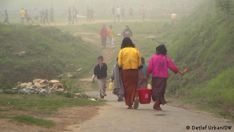 School children carry buckets of water in Bhutan 