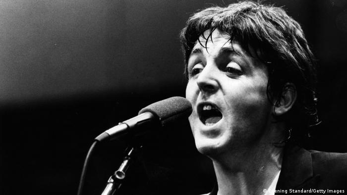 Paul McCartney singing in a microphone.