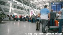 people wait in a long line in front of Tui Airways checkin counter at Duesseldorf airport on June 3, 2022 before the Pentecost holiday weekend. (Photo by Ying Tang/NurPhoto)