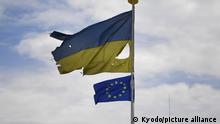 Ukrainian national flag and EU flag flutter in Malyn, Ukraine, on May 25, 2022, amid Russia's invasion of the country. (Kyodo)