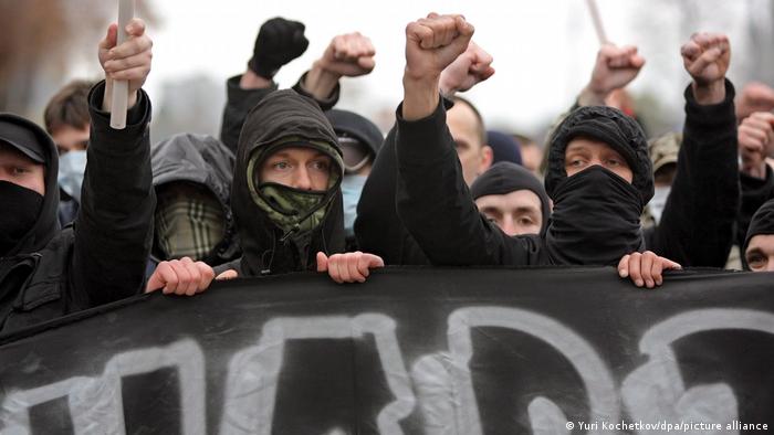 Black-clad, masked Russians participate in a sanctioned 2008 neo-Nazi rally in Moscow