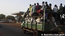 A truck with passengers and goods drives on a main road in Gorouol, near Burkina Faso, on June 9, 2022. - Nigerien President Mohamed Bazoum traveled on Thursday to the regions of Niger close to Burkina Faso and Mali, hit by recurrent jihadist attacks, where he notably visited displaced populations. (Photo by BOUREIMA HAMA / AFP)