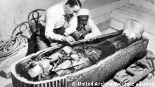 Mr. Howard Carter at work on the third and innermost coffin of Tutankhamen. 1922 Egypt / Mono Print