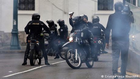 Riot police disperse demonstrators with tear gas during indigenous-led protests in Quito