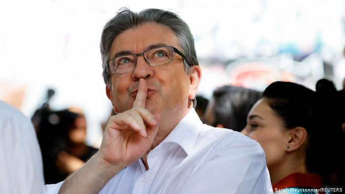 Jean-Luc Melenchon puts his finger to his lips