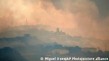 Smoke rises over San Martin de Unx in northern Spain, Sunday, June 19, 2022. Firefighters in Spain are struggling to contain wildfires in several parts of the country which as been suffering an unusual heat wave for this time of the year. (AP Photo/Miguel Oses)