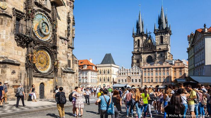 Tourists stand in the square in front of Prague's Astronomical Clock