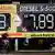 A imagem mostra um placar com os preços da gasolina e do diesel, em fundo verde e amarelo, com um ciclista passando em frente.