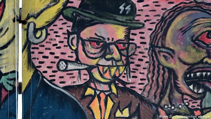 drawing of a character with a big nose and a cigar and sharp teeth, Nazi runes on his hat