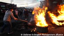 Demonstrators protest against the government of President Guillermo Lasso at a flaming barricade in Quito, Ecuador, Monday, June 20, 2022. (AP Photo/Dolores Ochoa)