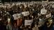 Demonstrators hold banners and lights during a public rally in front of the Parliamentary building in Tbilisi, Georgia Demonstrators hold banners and lights during a public rally in front of the Parliamentary building in Tbilisi, Georgia
