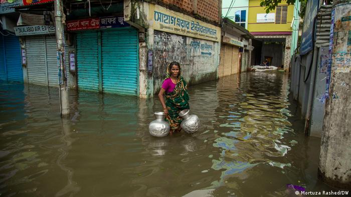Bangladesch Frau auf der Suche nach Trinkwasser nach Überflutungen durch den Monsunregen