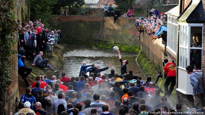 The two sides engage in a match of Royal Shrovetide Football