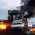 Smoke rises from burning road blockades as Indigenous demonstrators drive in a truck headed toward the Ecuadorian capital Quito